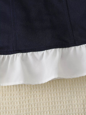 Navy polo dress detail with white ruffled hem