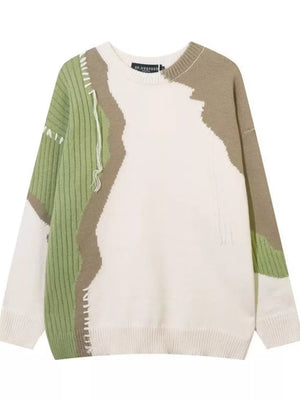Contrast knit sweater with abstract green and tan color block pattern and textured details.