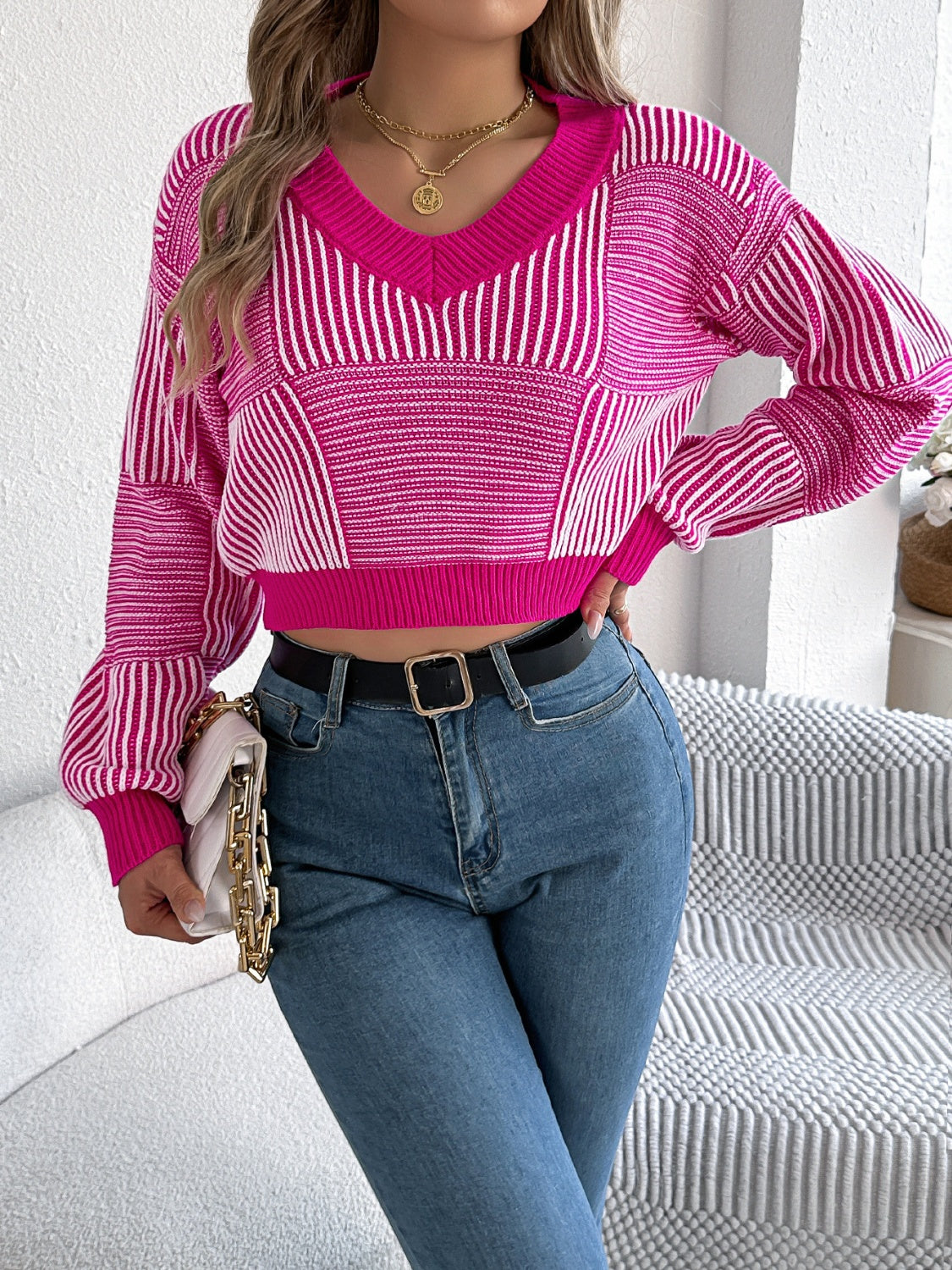 Hot pink and white geometric stripe cropped v-neck knit sweater with balloon sleeves.