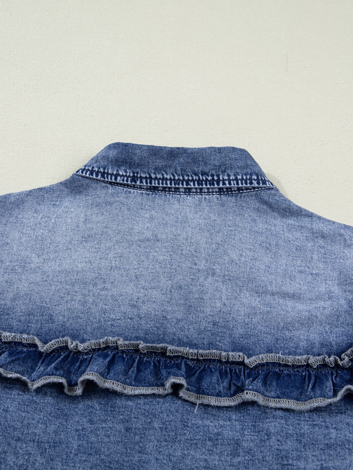 Denim ruffle button-down shirt with vintage wash and frayed ruffle detail
