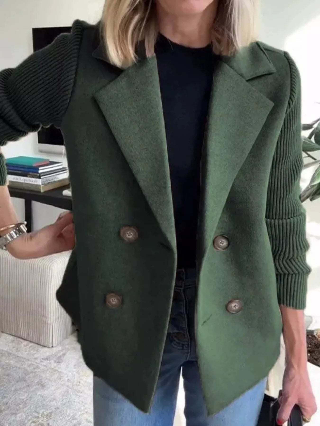 Green double-breasted wool blend blazer with contrasting knit sleeves and button details.