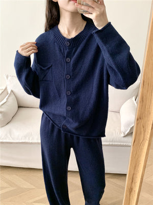 Dark blue ribbed knit cardigan and wide leg pants set with button front and pocket detail.