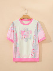 Maternity t-shirt with crew neck, short sleeves, floral patchwork pattern, and pink accents.