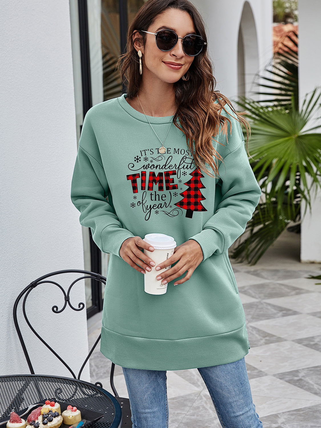 Sage tunic sweatshirt with holiday graphic, crew neck, long sleeves, and side pockets.
