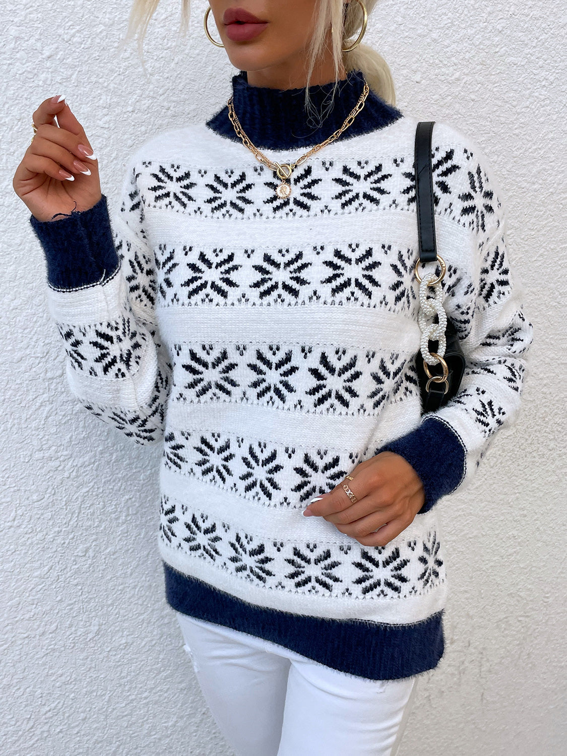 White mock neck sweater with navy fair isle snowflake pattern and navy cuffs.
