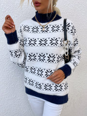 White mock neck sweater with navy fair isle snowflake pattern and navy cuffs.