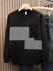 Men's black long sleeve sweater with striped and textured block details and a chest pocket.