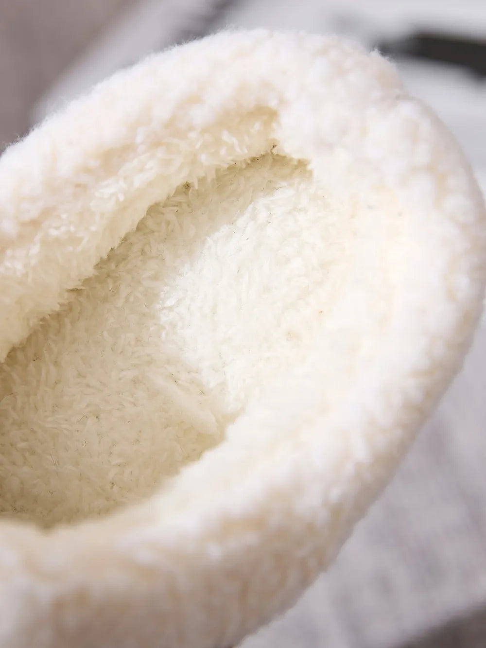 Suede shearling-lined moccasin slipper interior detail, plush and cozy.
