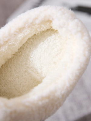 Suede shearling-lined moccasin slipper interior detail, plush and cozy.