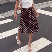 Dark brown polka dot A-line skirt with a bow detail at the waist.
