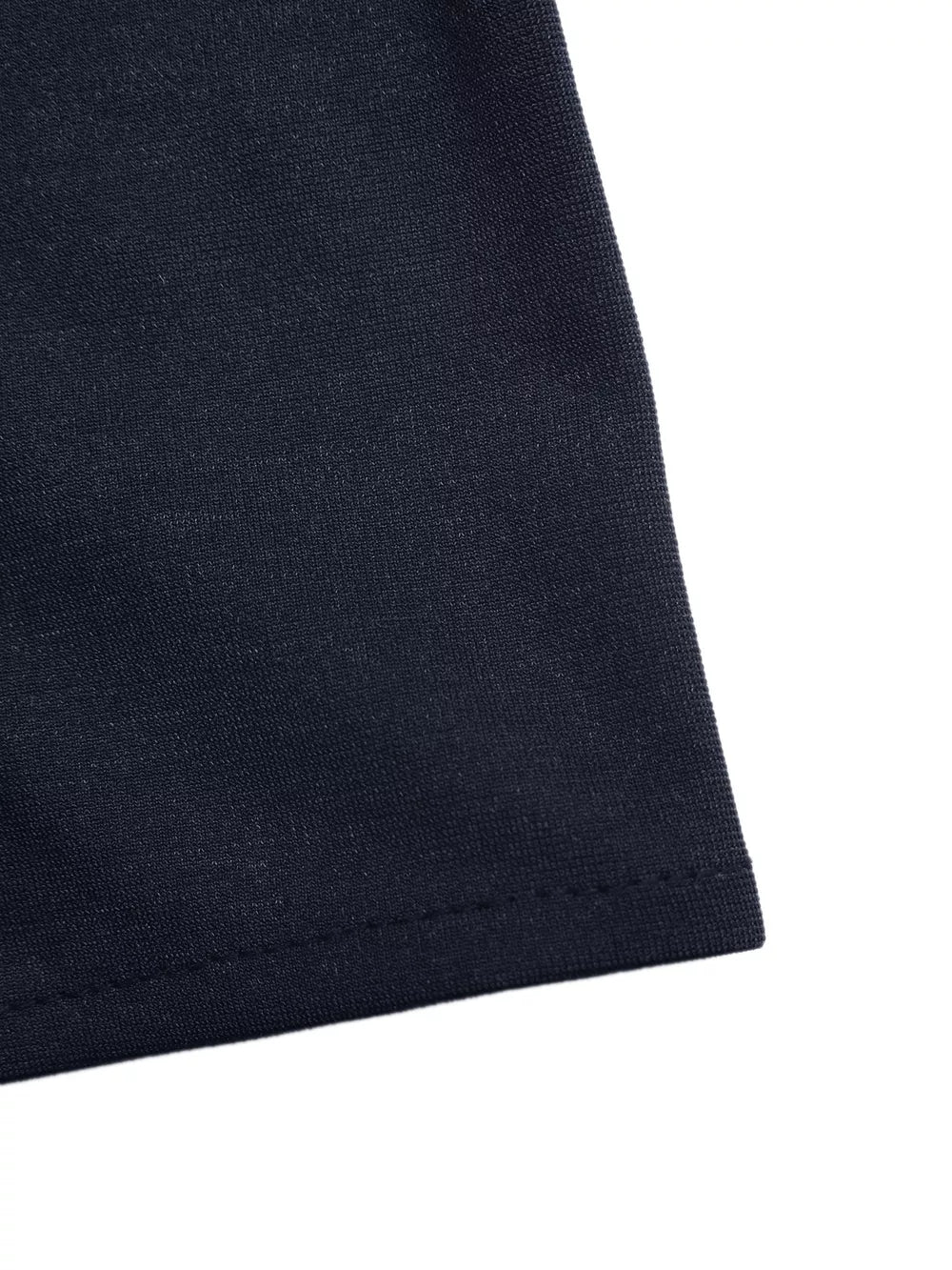 Dark navy vest detail showing textured fabric and hem stitching.