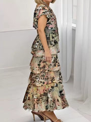 Ruffled tiered maxi dress in multicolor floral print with ruffle trim and short sleeves.