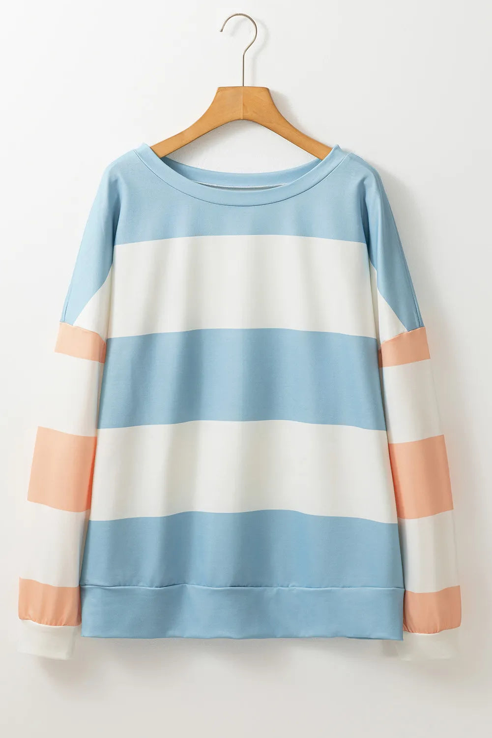 Striped sweatshirt with block sleeves in light blue, white, and blush pink.