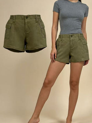 Green cargo shorts with elastic waist and button fly, featuring multiple pockets.