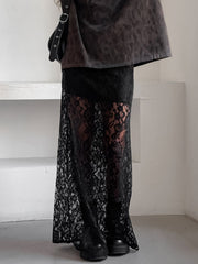 Black lace maxi skirt with sheer detail and scalloped hem, worn with boots.