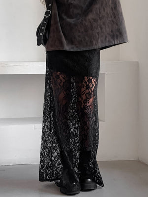 Black lace maxi skirt with sheer detail and scalloped hem, worn with boots.