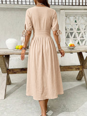 Tan button-down midi dress with tie sleeve details and a-line skirt
