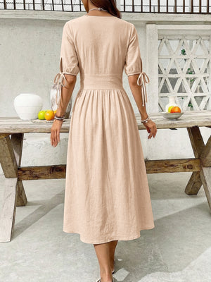 Tan button-down midi dress with tie sleeve details and a-line skirt