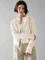 Cream waffle knit cropped hoodie with snap front and zipper detail.