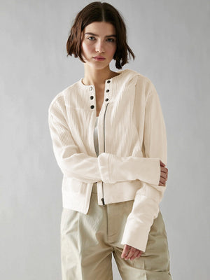 Cream waffle knit cropped hoodie with snap front and zipper detail.