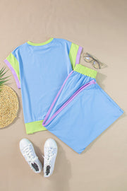 Colorblock sportswear set with light blue top and pants, contrast trim, and lime green accents.