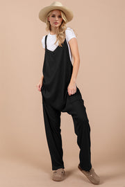 Black harem overalls with V-neck, adjustable straps, and zip pockets.