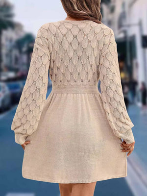 Tan openwork knit V-neck sweater dress with cinched waist and above knee length.