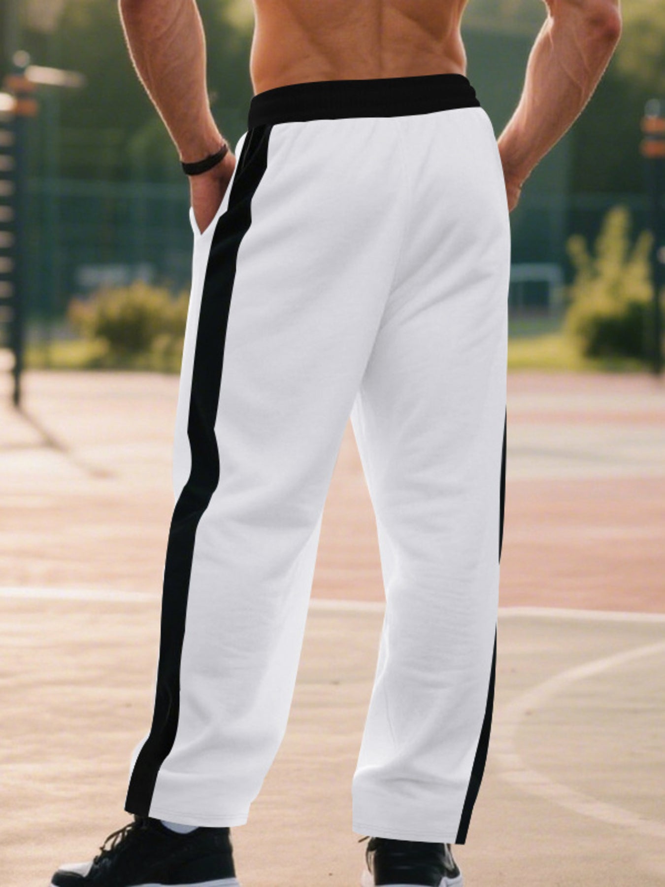 Men's white sweatpants with black side stripes and drawstring waist.