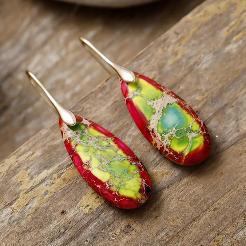 Marbled gemstone teardrop earrings in red, green, yellow, and blue with gold hooks.
