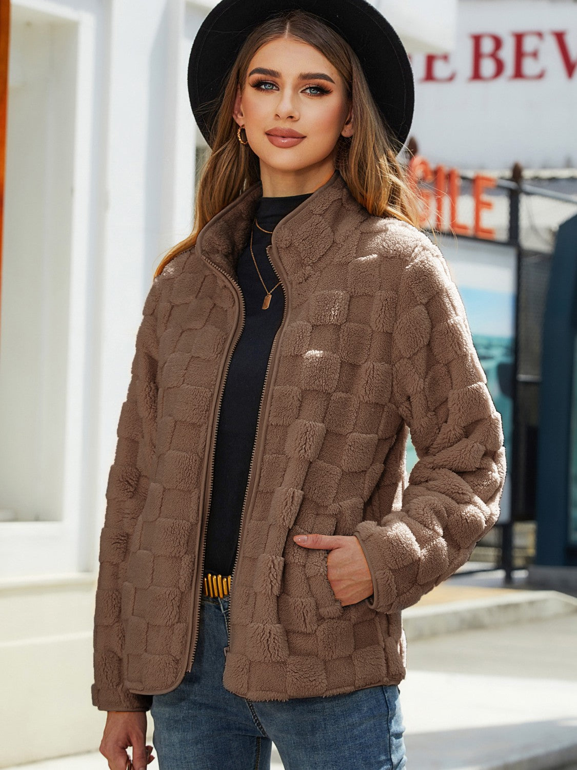 Brown textured grid zip-up jacket with a stand-up collar and pockets.