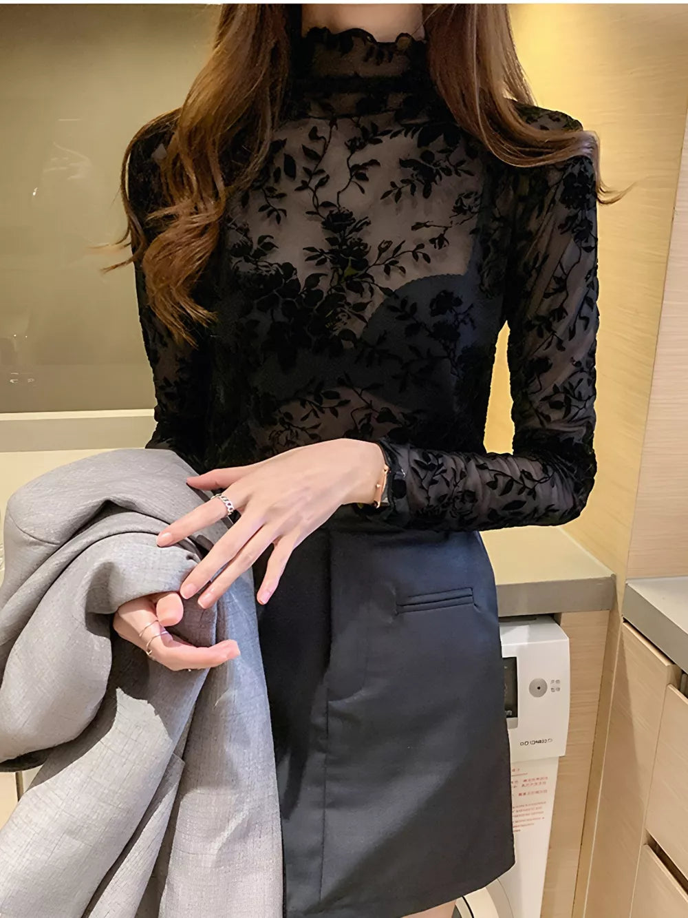 Black sheer floral fitted long sleeve t-shirt with mock neck and ruffled trim.