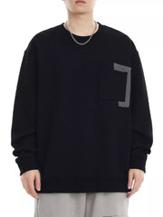 Black crew neck sweatshirt with textured fabric and chest pocket detail