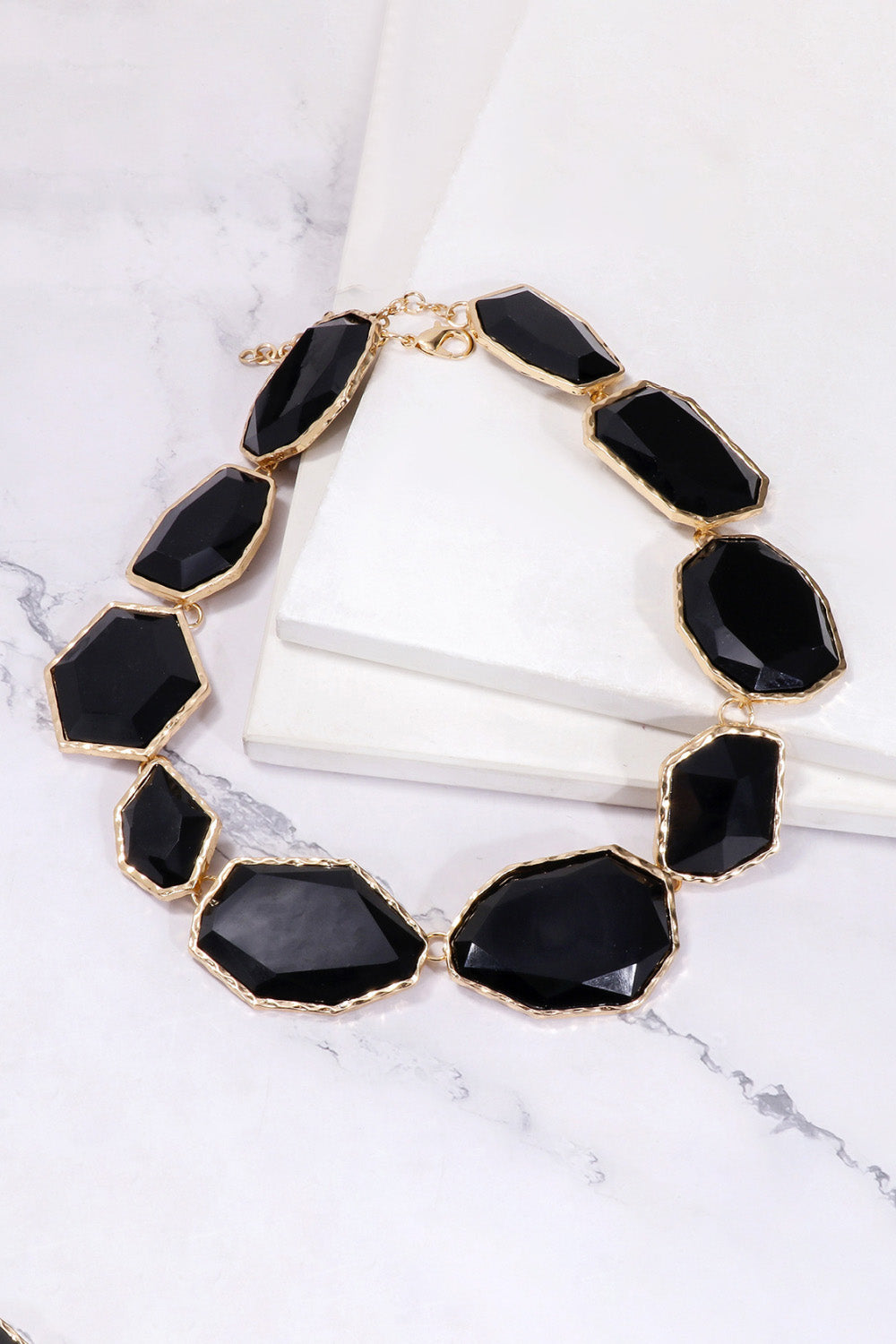 Black resin stone collar necklace with gold-tone alloy setting.