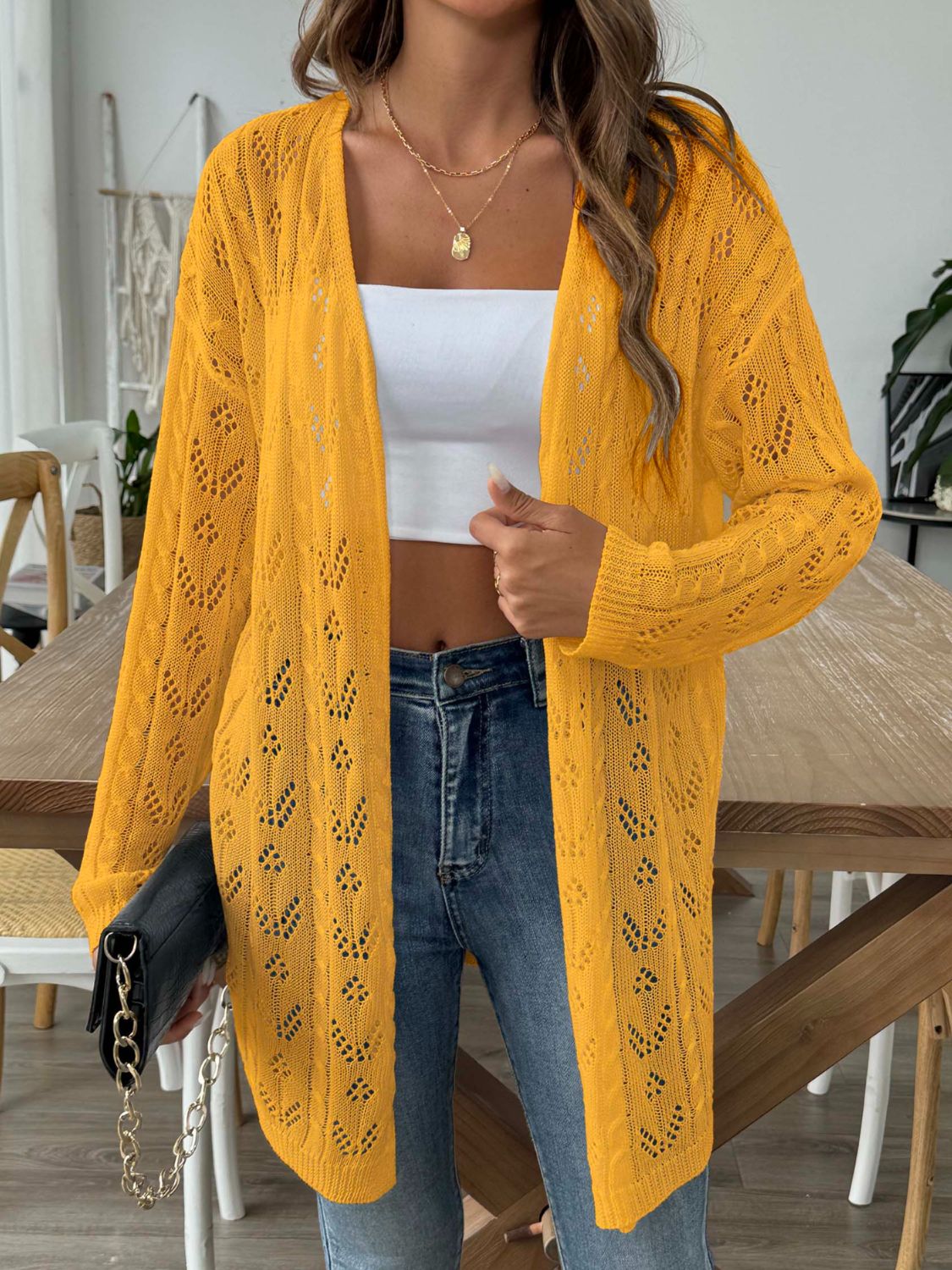 Openwork diamond knit duster cardigan in gold with long sleeves and an open front.