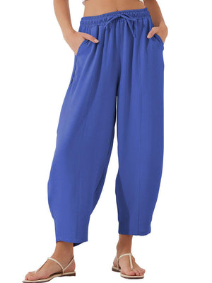 Royal blue balloon-leg drawstring trousers with seam detail and pockets.