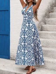 Blue and white medallion print halter maxi dress with a deep V-neck and flowing skirt.