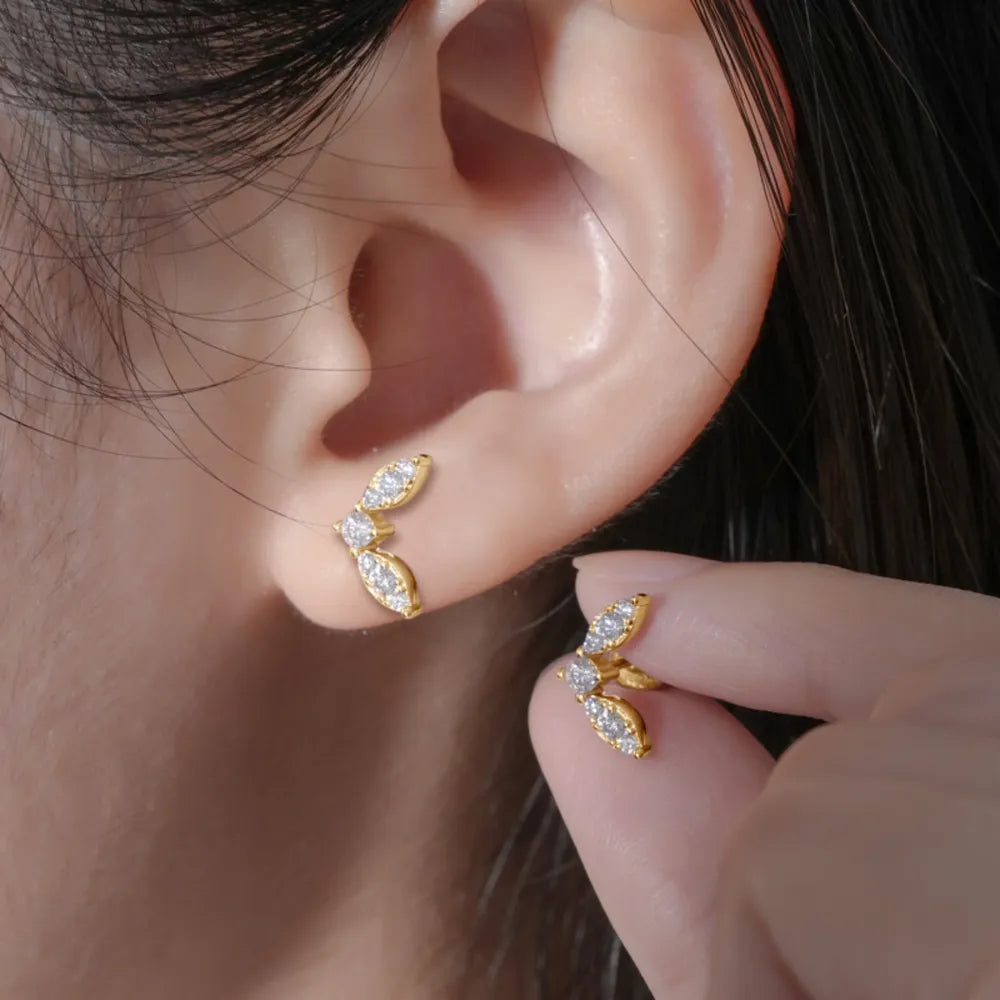 Gold moissanite leaf cluster stud earrings with cubic zirconia accents.