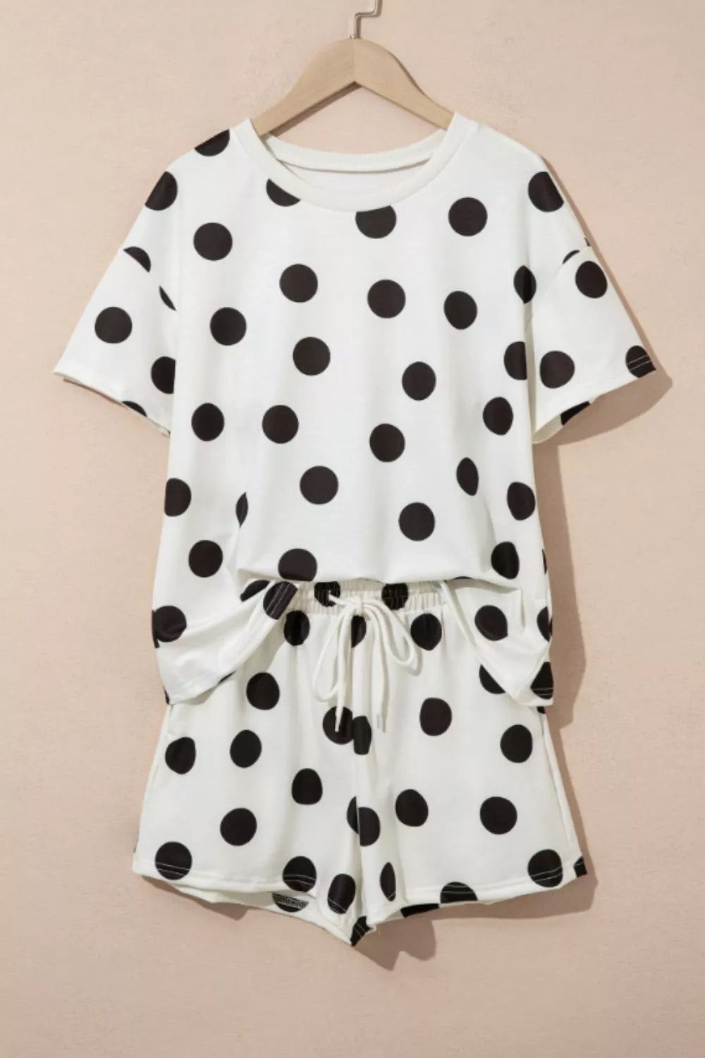 White polka dot loungewear set with crew neck top and drawstring shorts.