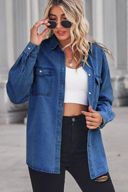 Oversized denim shirt in dark blue with patch pockets, collared neck, and buttoned front.