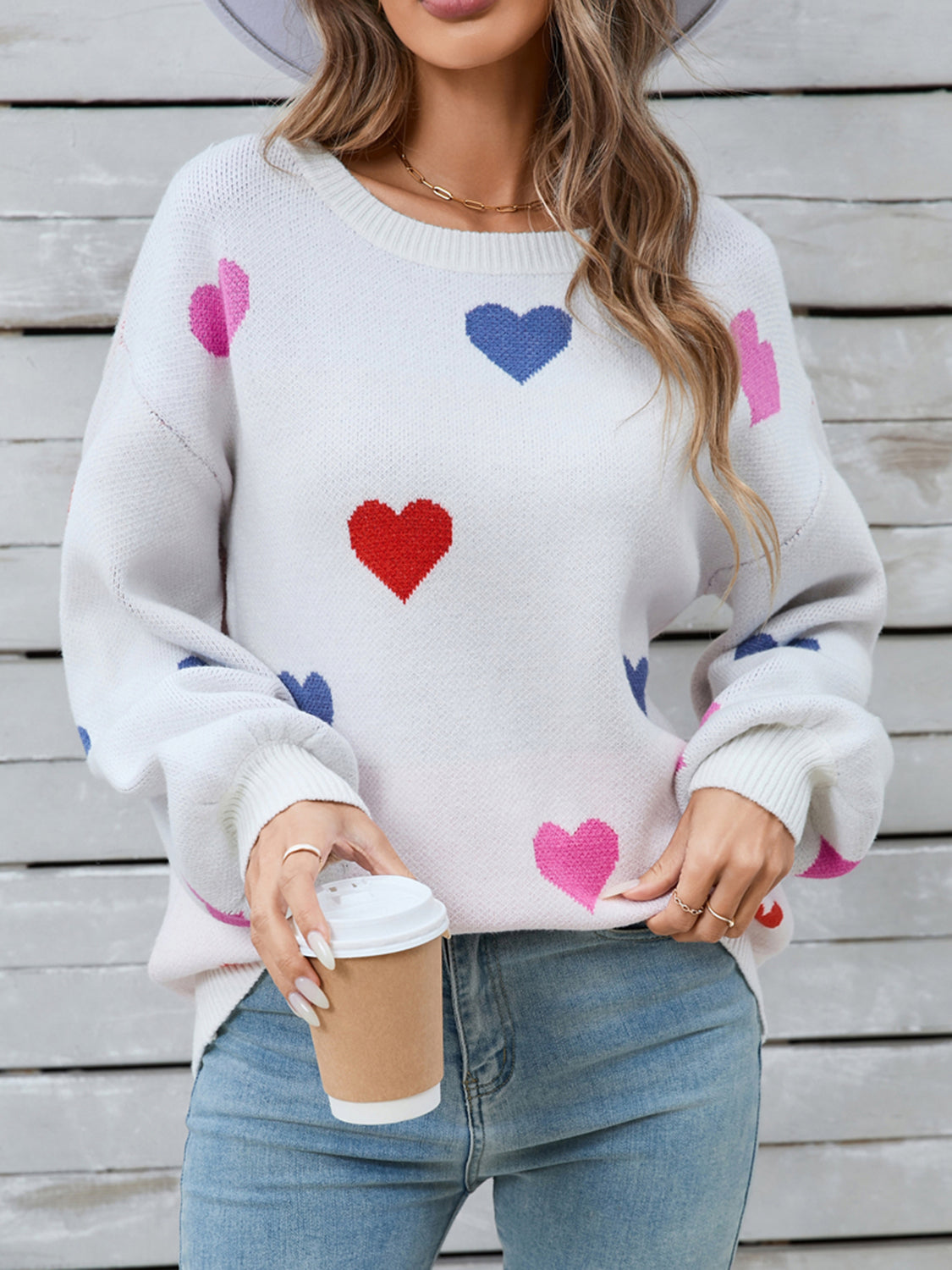 White knit sweater with pink, blue, and red heart motif, bubble sleeves