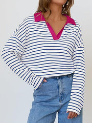 Oversized striped long-sleeve sweatshirt with a bright pink collar and V-neck.