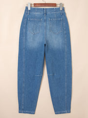 High-waisted blue denim barrel jeans with cuffed ankles and subtle knee details.