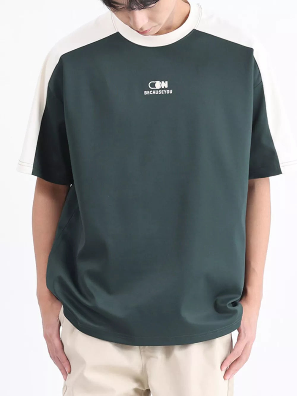 Men's dark green t-shirt with white contrast sleeves and stitching.