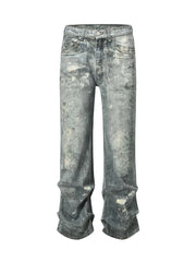 Distressed wide-leg jeans in medium wash denim with painterly details and a casual fit.