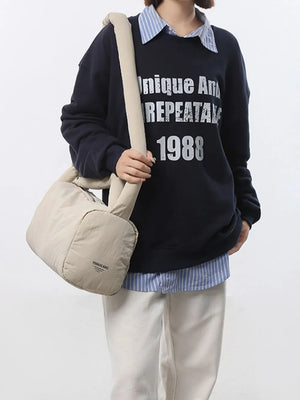 Beige padded knot shoulder bag with a casual, modern style.