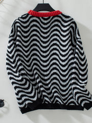 Black and white wavy stripe knit sweater with red contrast collar.