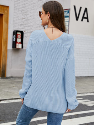 Misty Blue ribbed knit sweater with V-neck and subtle sleeve detail.