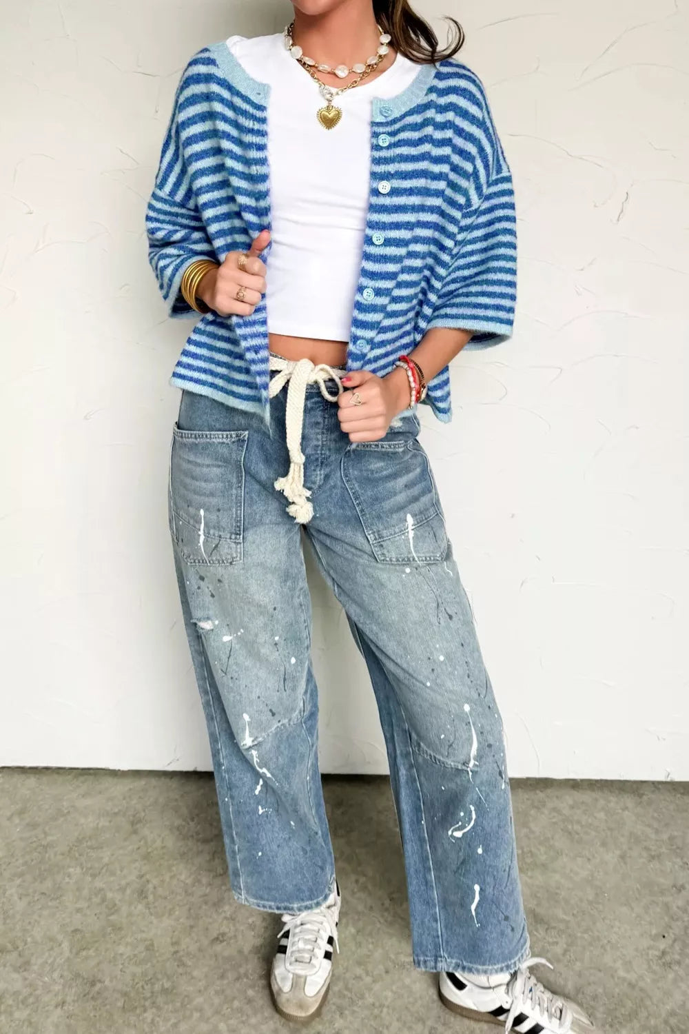 Cropped blue striped knit cardigan with buttons and light blue trim.
