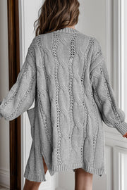 Light gray cable knit open-front cardigan with pockets and openwork details.