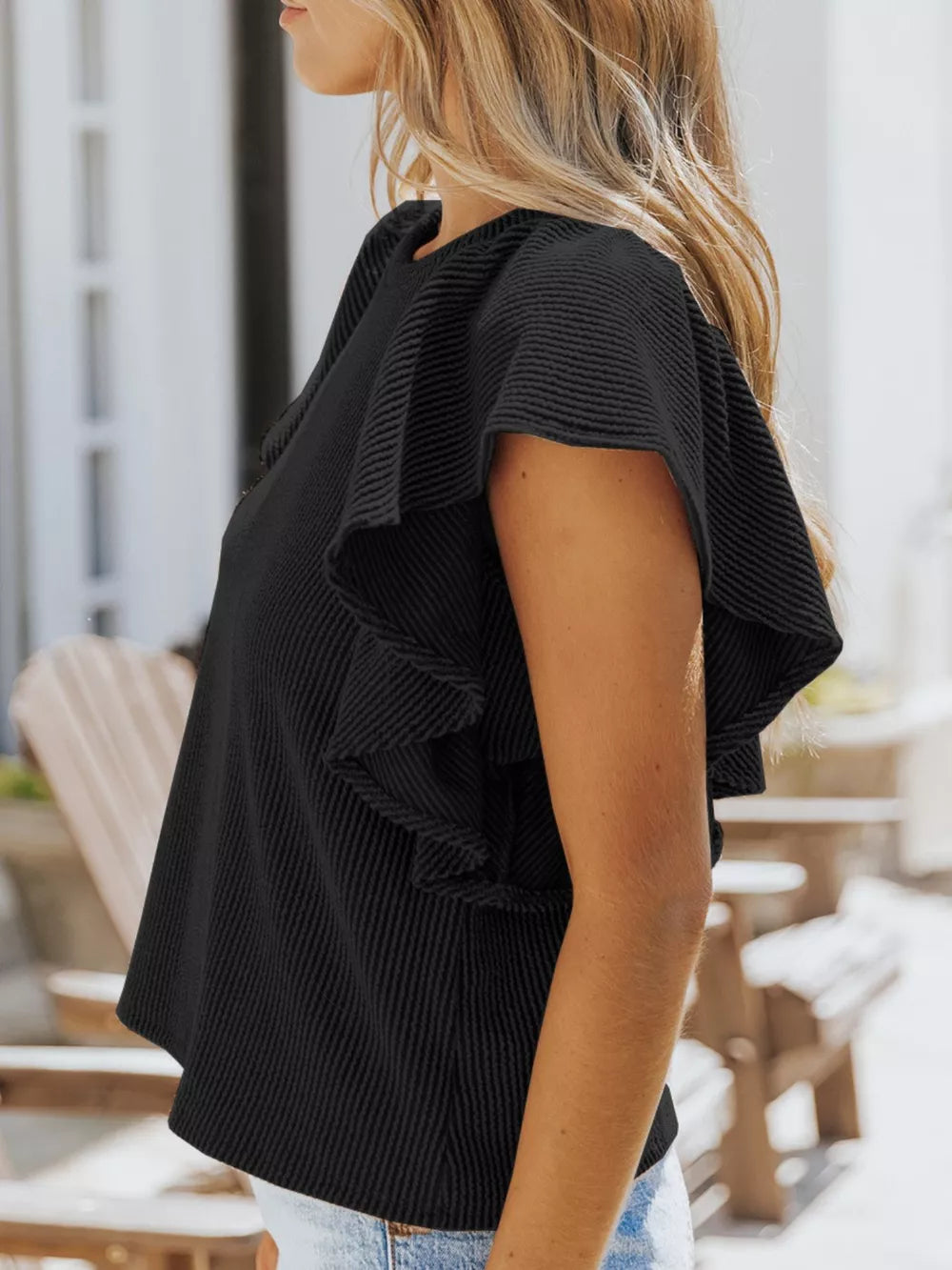 Black ribbed t-shirt with ruffled short sleeves and crew neck.